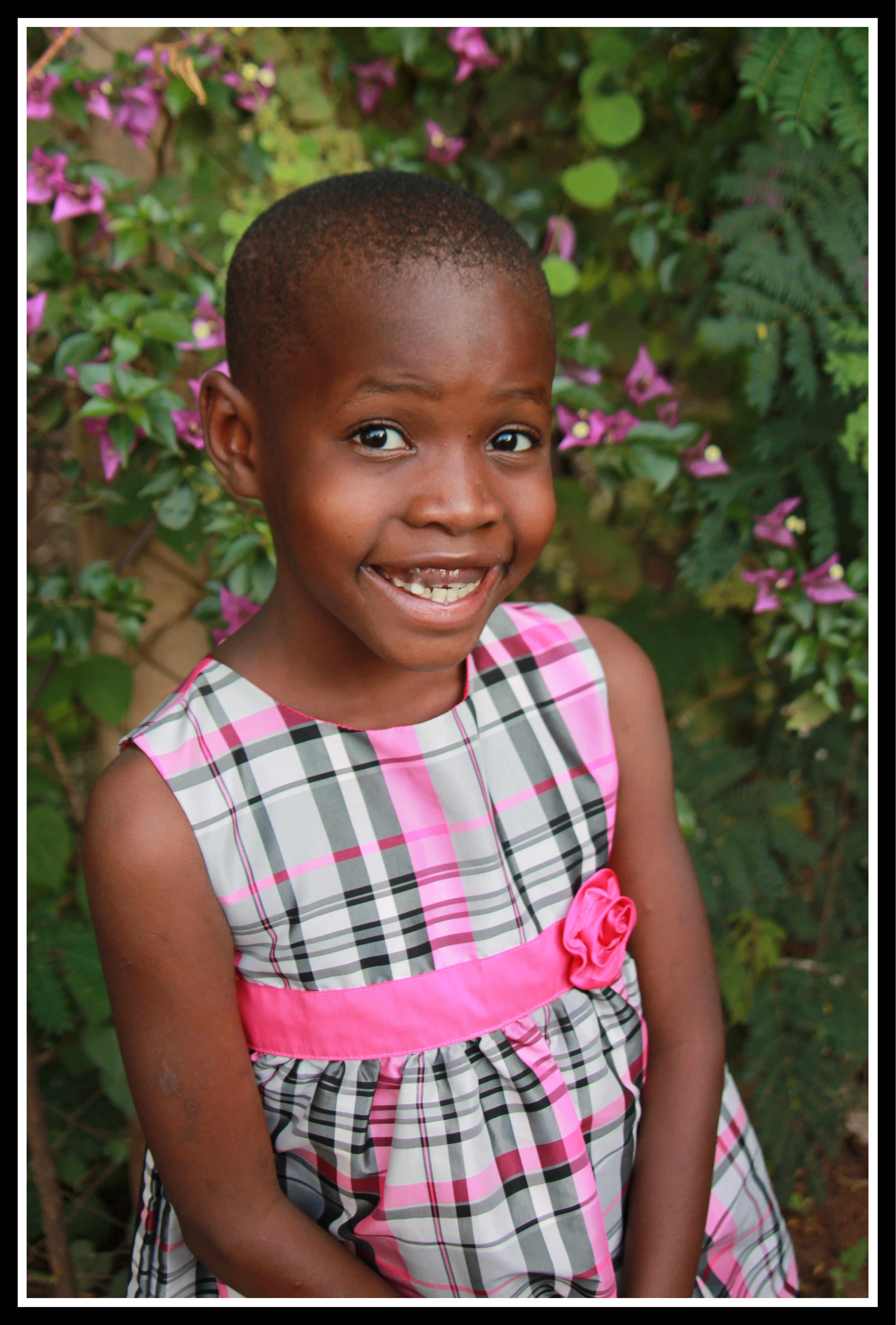 Justina age 7 in her Christmas dress at Treasures of Africa